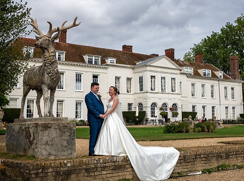 Wedding couple walking together at Gosfield Hall wedding venue in Essex