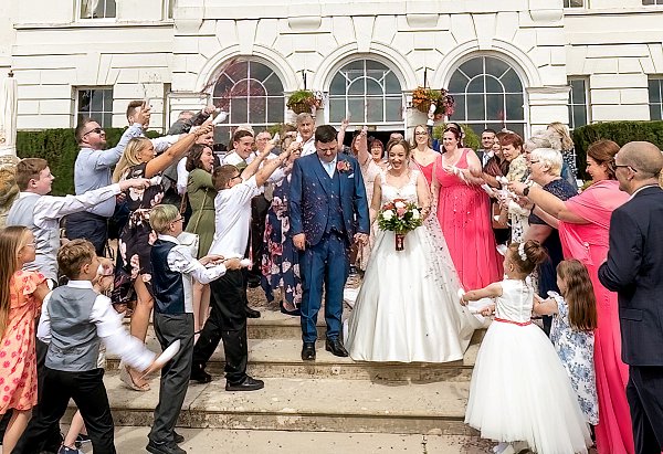 Wedding confetti moment in the courtyard at Gosfield Hall