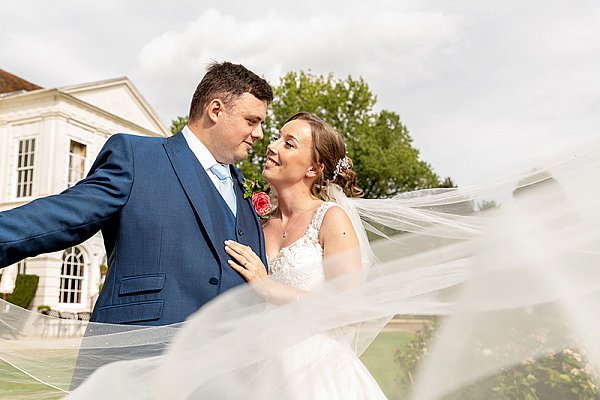 Wedding couple walking the grounds of Gosfield Hall Essex