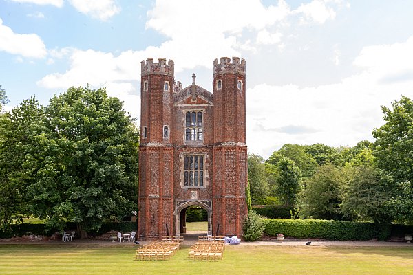Bride and groom outside the Great Tower at Leez Priory wedding venue in Essex